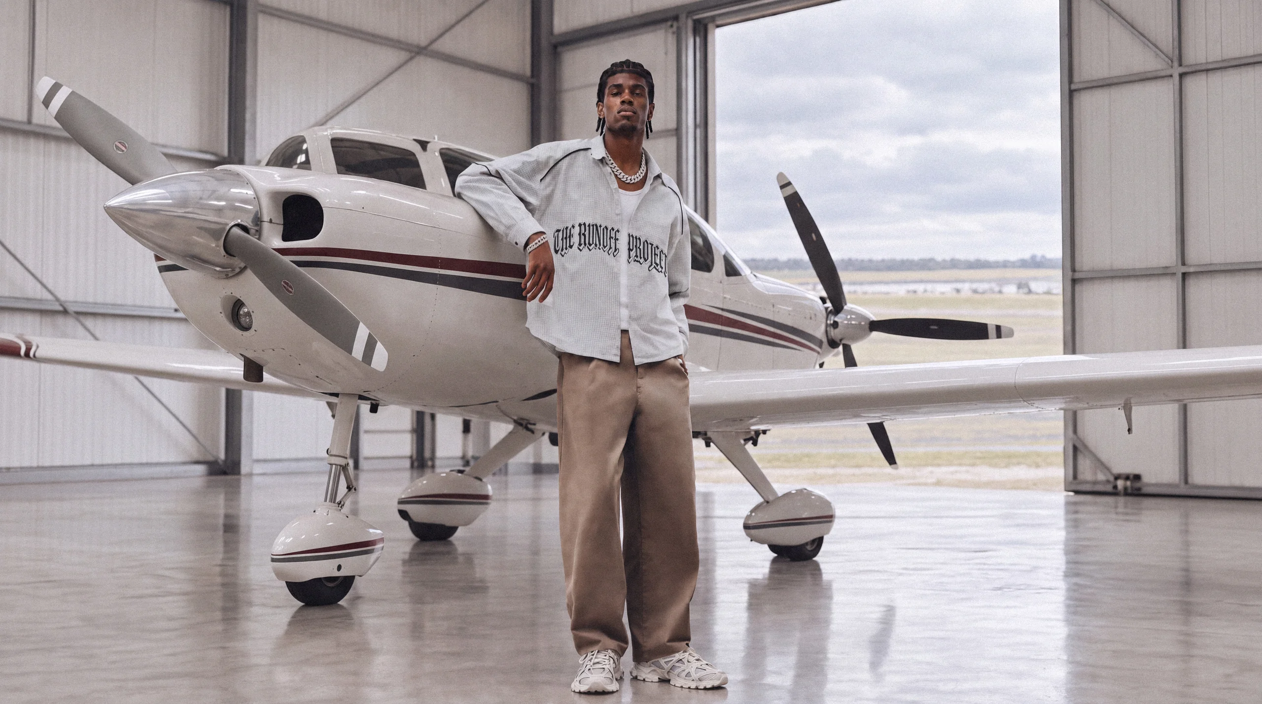 The Runoff Project campaign, photographed beside an aircraft in a hangar